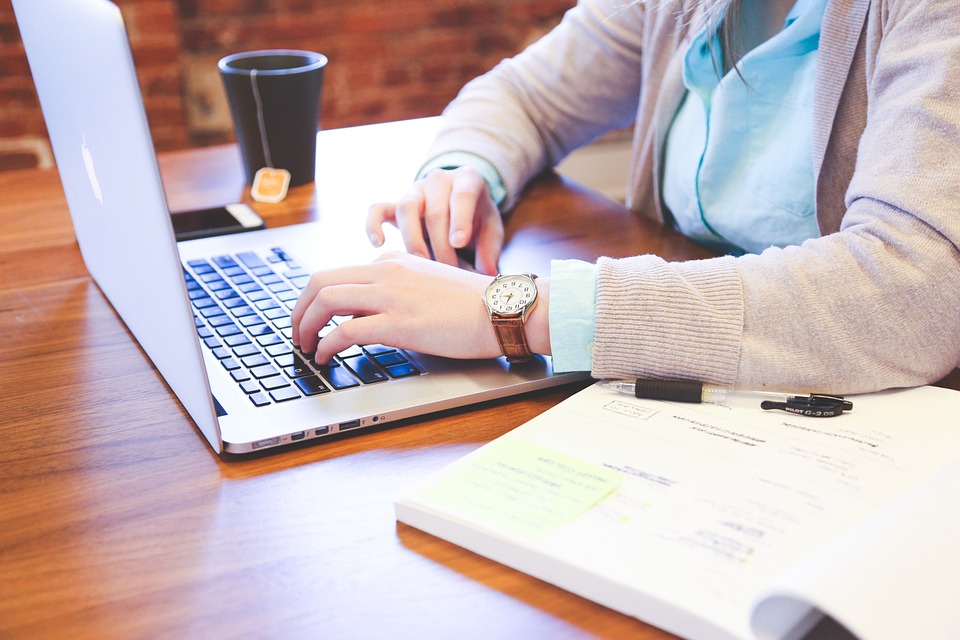 woman typing on laptop